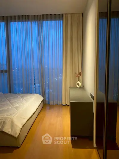 Modern bedroom with floor-to-ceiling windows and elegant decor