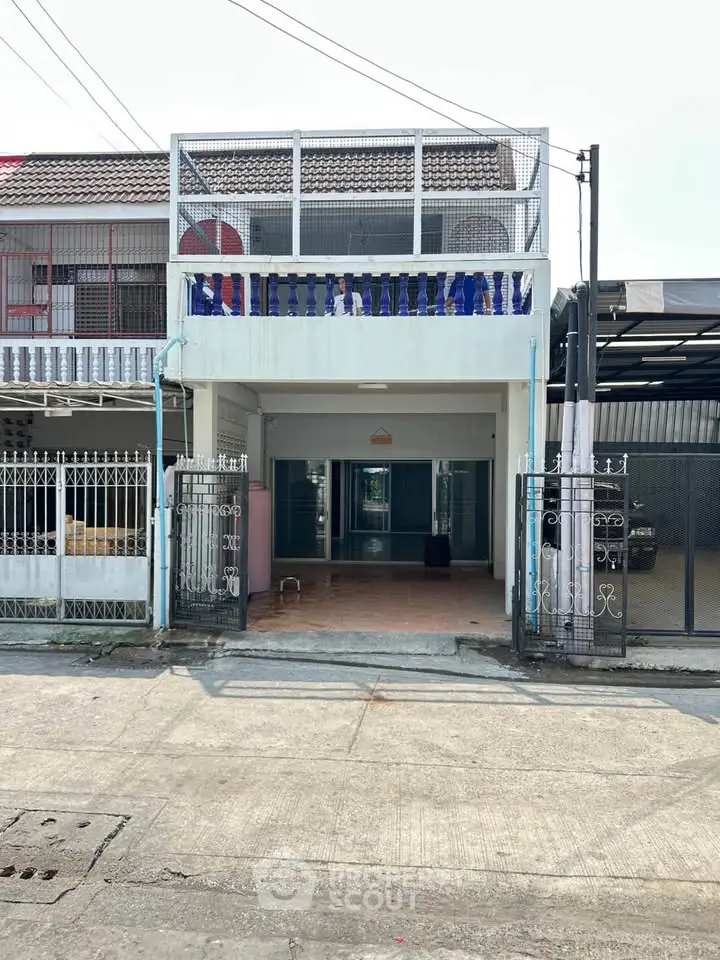 Charming two-story townhouse with gated entrance and spacious balcony in a quiet neighborhood.