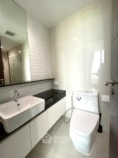 Modern bathroom with sleek fixtures and large mirror