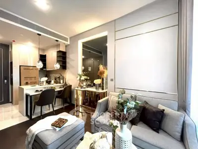 Modern open-layout living room with stylish decor and kitchen area