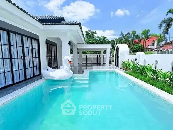 Luxurious villa with private pool and elegant architecture in tropical setting.