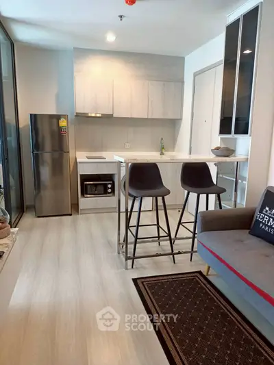 Modern kitchen with sleek appliances and breakfast bar in stylish apartment