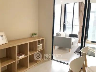 Modern living room with sleek furniture and large windows offering natural light.