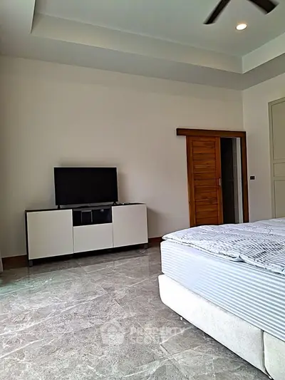 Spacious bedroom with modern decor and sleek flooring