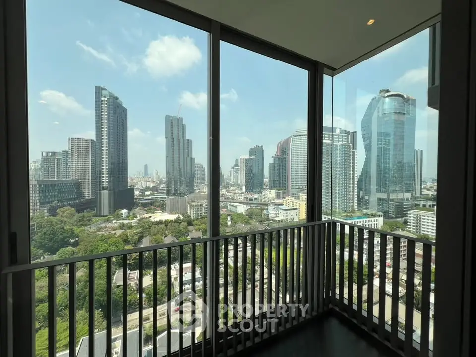 Stunning cityscape view from a modern high-rise balcony with floor-to-ceiling windows.
