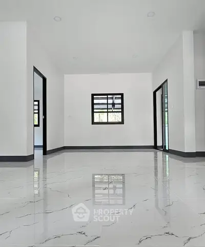 Spacious modern interior with glossy marble flooring and large windows.