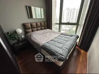 Modern bedroom with city view, featuring a cozy bed and stylish decor in a high-rise apartment.