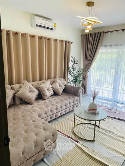 Elegant living room with plush sofa, modern decor, and large window for natural light.