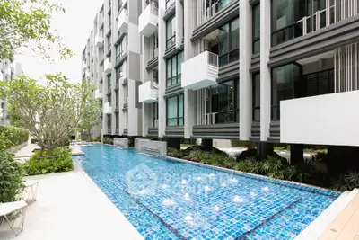 Modern condominium with sleek architecture and inviting outdoor pool area.
