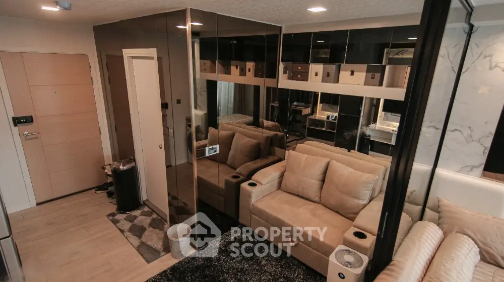Modern living room with mirrored walls and beige sofa in stylish apartment
