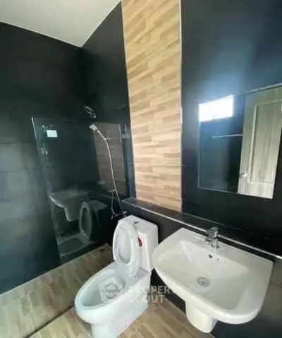 Modern bathroom with sleek black tiles and stylish fixtures