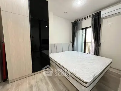 Modern bedroom with sleek wardrobe and large window for natural light