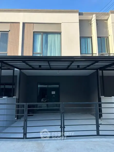 Modern townhouse exterior with sleek design and gated entrance