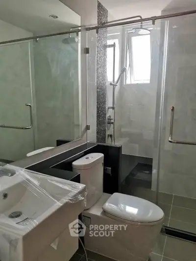 Modern bathroom with glass shower and sleek fixtures
