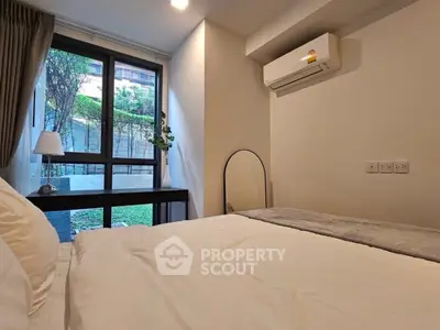 Cozy bedroom with garden view and modern air conditioning unit