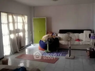 Spacious living room with natural light and cozy seating area.