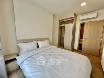 Modern bedroom with cozy bed and built-in wardrobe in a stylish apartment.