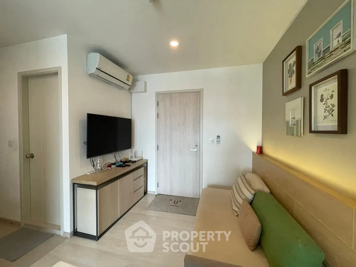 Modern living room with stylish decor and wall-mounted TV, perfect for cozy relaxation.