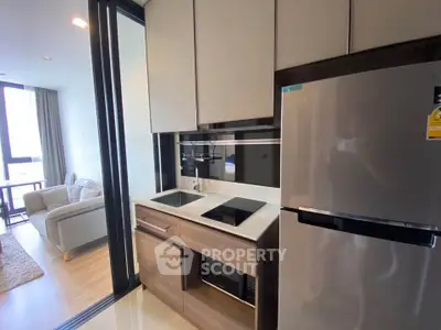 Modern compact kitchen with sleek appliances and open layout in stylish apartment