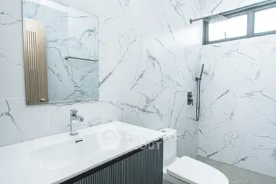 Modern bathroom with sleek marble tiles and contemporary fixtures
