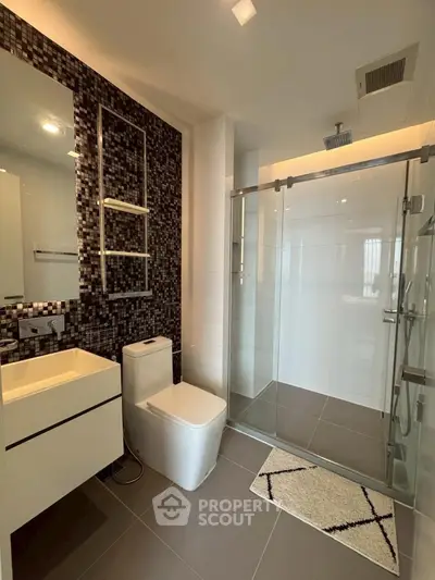 Modern bathroom with sleek design and glass shower enclosure