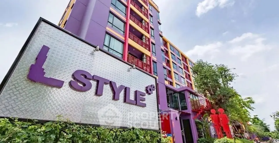 Vibrant purple apartment building with modern design and lush greenery, perfect for urban living.