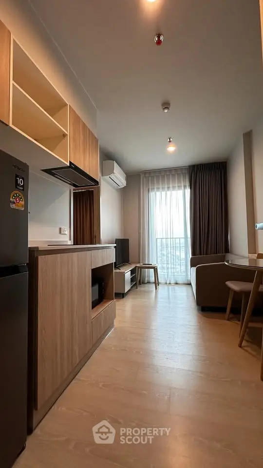 Modern living room with open kitchen and balcony view in stylish apartment