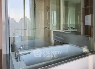 Luxurious bathroom with city view and modern bathtub in high-rise apartment