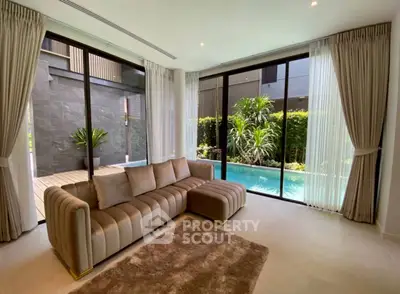 Luxurious living room with pool view and elegant sofa