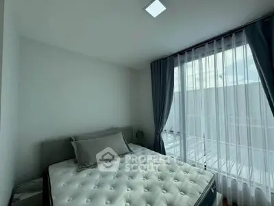 Bright bedroom with large window and modern decor