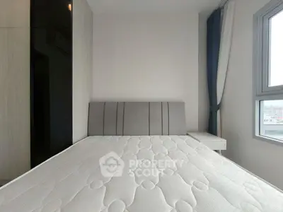 Modern bedroom with large window and sleek design