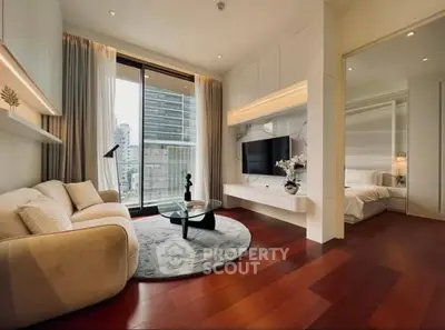 Luxurious modern living room with hardwood floors, large window, and stylish decor in a high-rise apartment.