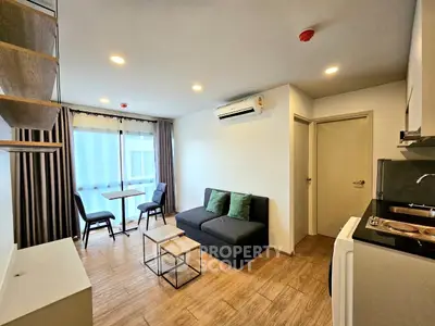 Modern living room with compact kitchen and stylish decor