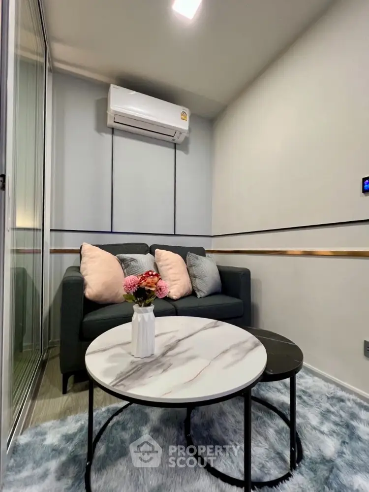 Cozy living room with modern sofa and stylish coffee tables, perfect for relaxation.