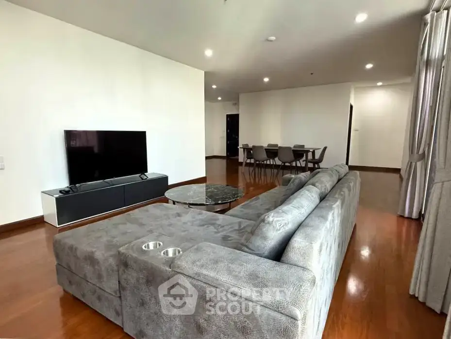 Spacious modern living room with sleek furniture and open layout, perfect for entertaining.