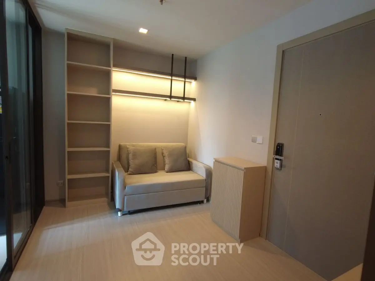 Modern living room with cozy sofa and built-in shelves, perfect for urban living.