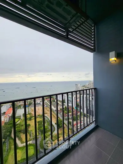 Stunning high-rise balcony with panoramic ocean view and modern railing design.
