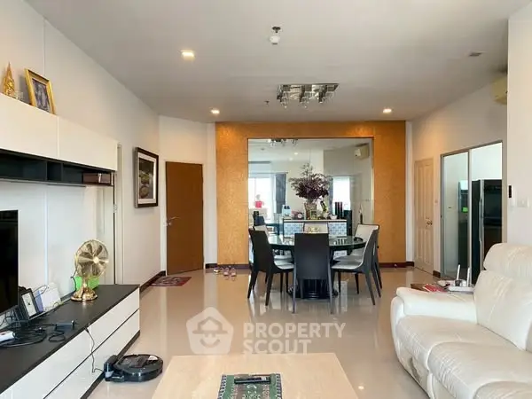 Spacious living room with modern dining area and sleek decor