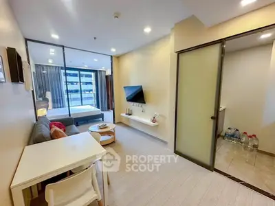 Modern studio apartment with open layout and sleek design, featuring a cozy living area and bedroom.