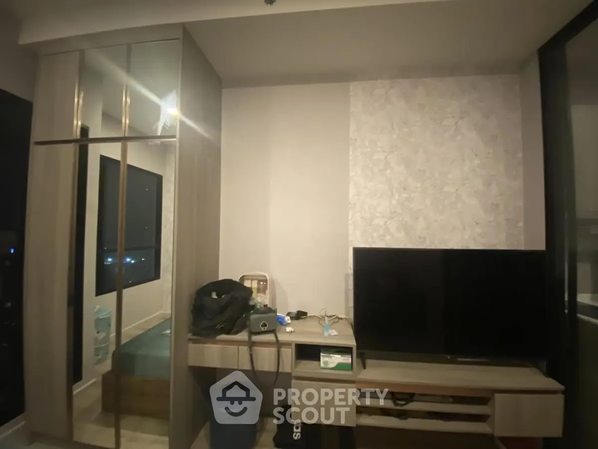 Modern living room with sleek TV unit and mirrored wardrobe
