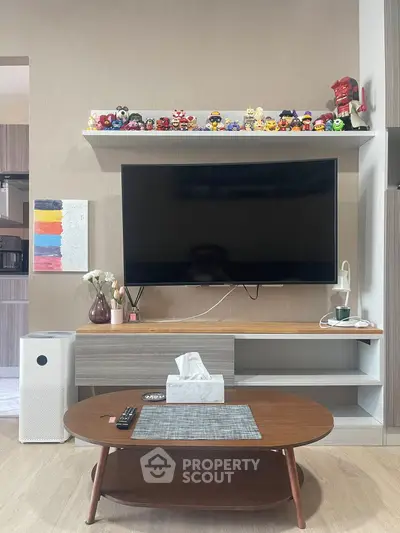Modern living room with sleek TV setup and stylish wooden coffee table.