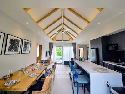 Stunning open-plan living and dining area with high ceilings and modern decor, perfect for entertaining.