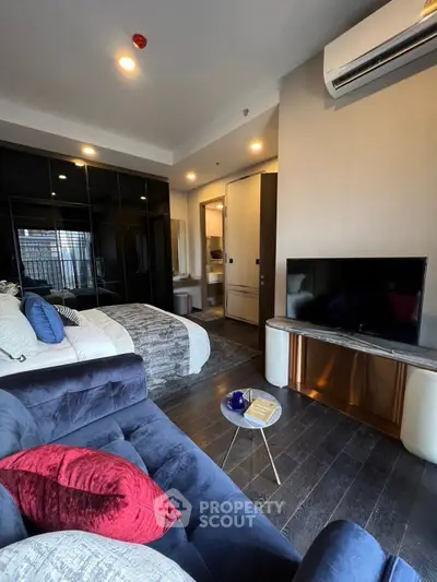 Luxurious modern bedroom with sleek design, featuring a cozy bed, stylish sofa, and a flat-screen TV for ultimate comfort.