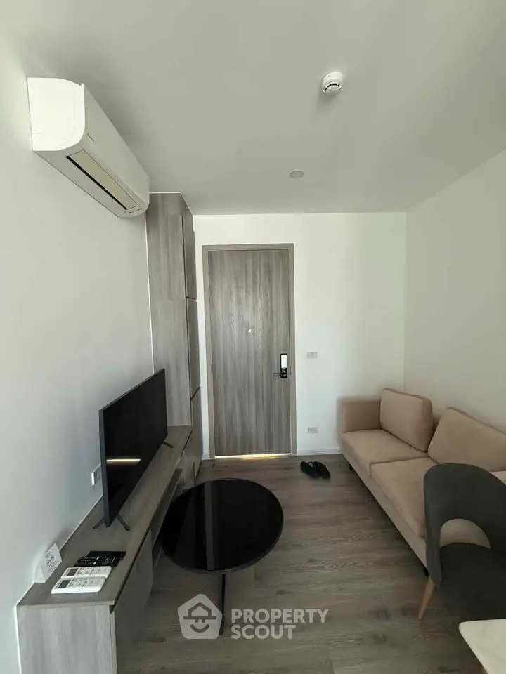 Modern living room with sleek furniture and air conditioning in a stylish apartment.