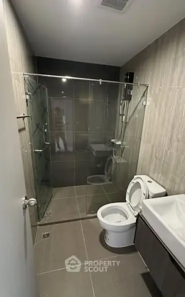 Modern bathroom with glass shower and sleek fixtures