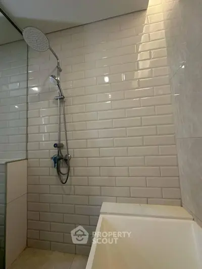 Modern bathroom with sleek shower and white subway tiles