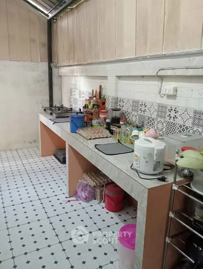 Charming kitchen with tiled backsplash and open shelving, perfect for culinary enthusiasts.
