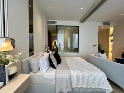 Luxurious modern bedroom with elegant decor and large window view.