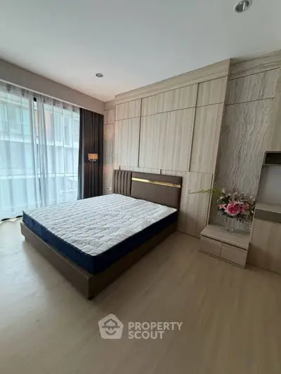 Spacious bedroom with modern design and large window for natural light