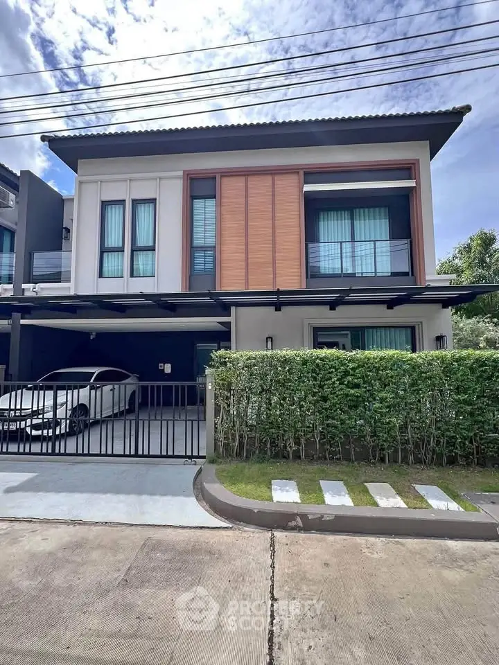 Modern two-story house with sleek design and spacious driveway